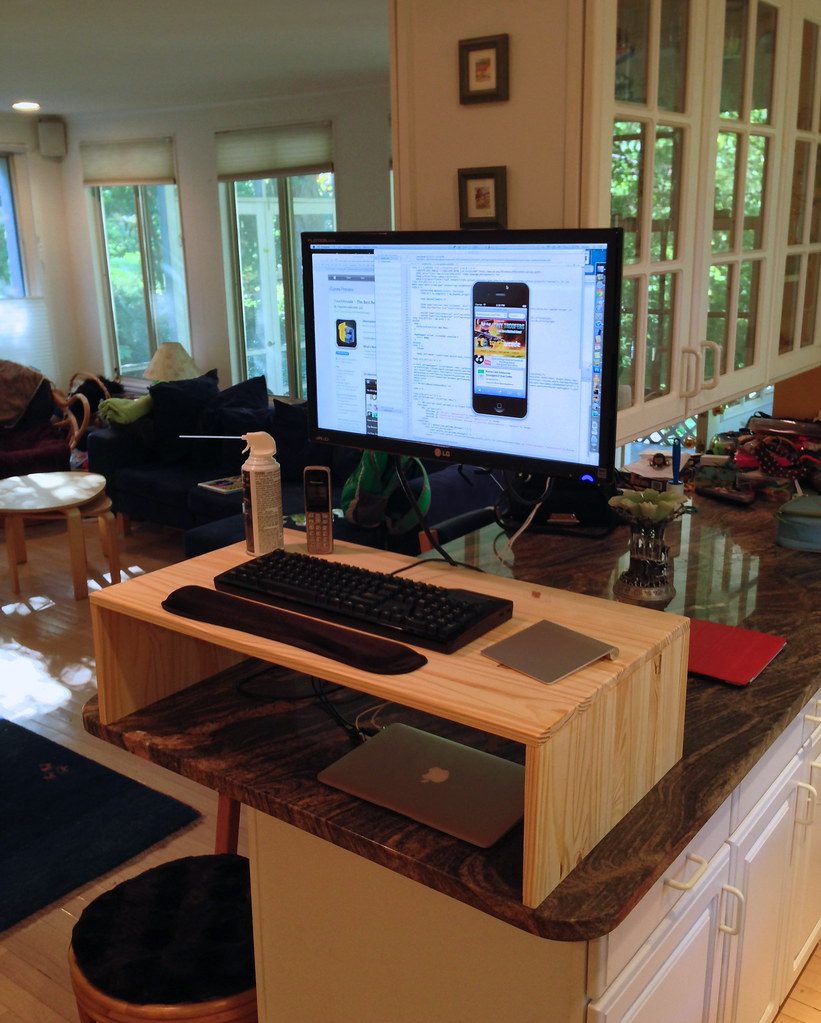 A standing-desk workspace illustrating a healthier all-day desk arrangement